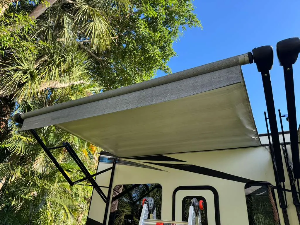 Tidepool RV technician replacing an RV awning at a Florida campground