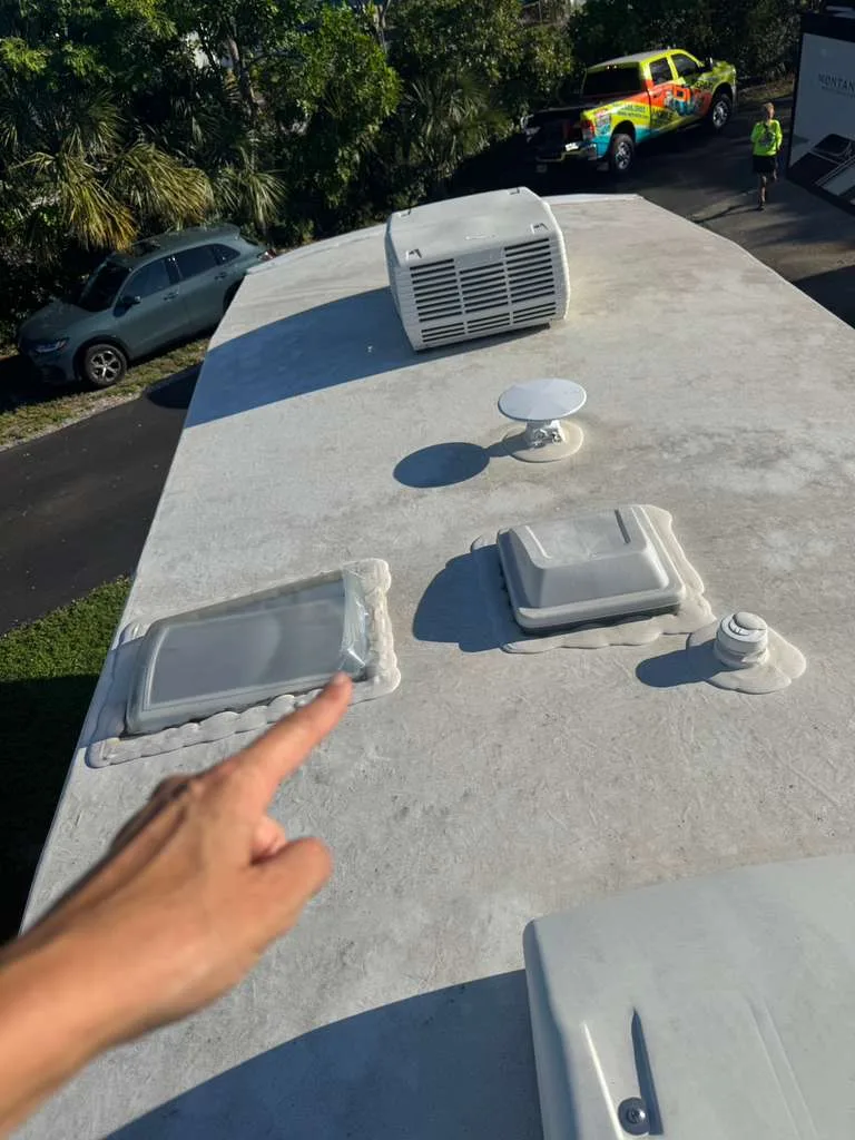 Tidepool RV technician repairing a rubber roof leak on an RV in Florida